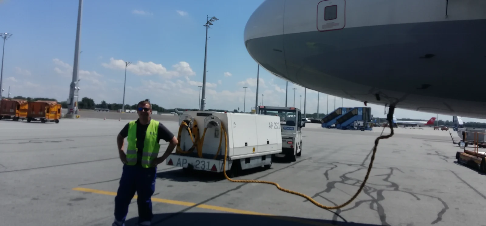 Jaroslav Brezina, founder of Walk-Check, on the airport apron beside an aircraft during a turnaround.
